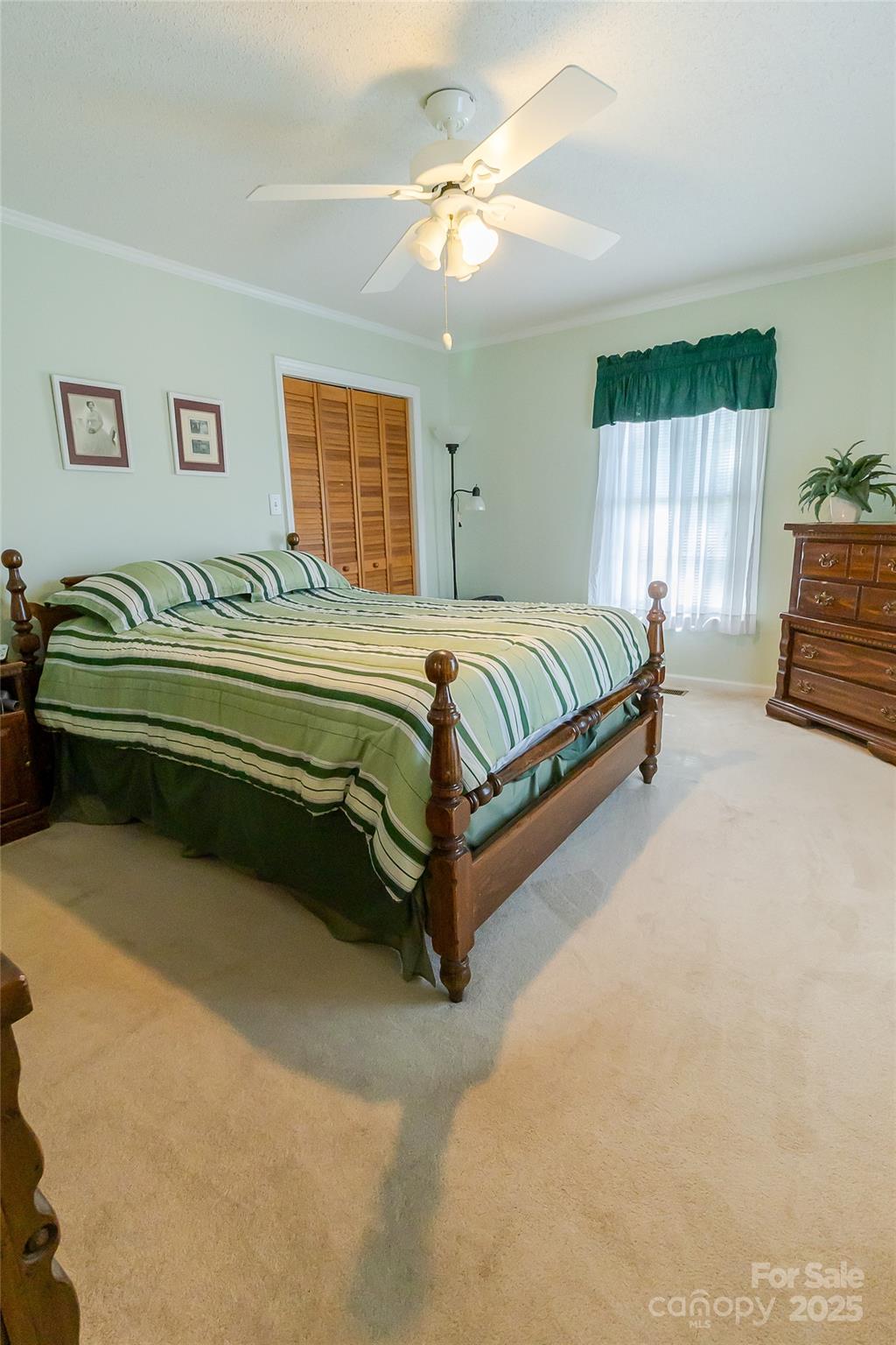 535 Holly Ridge Road Grover, NC 28073 - Photo 23 of 40 a bedroom with a bed and a chandelier