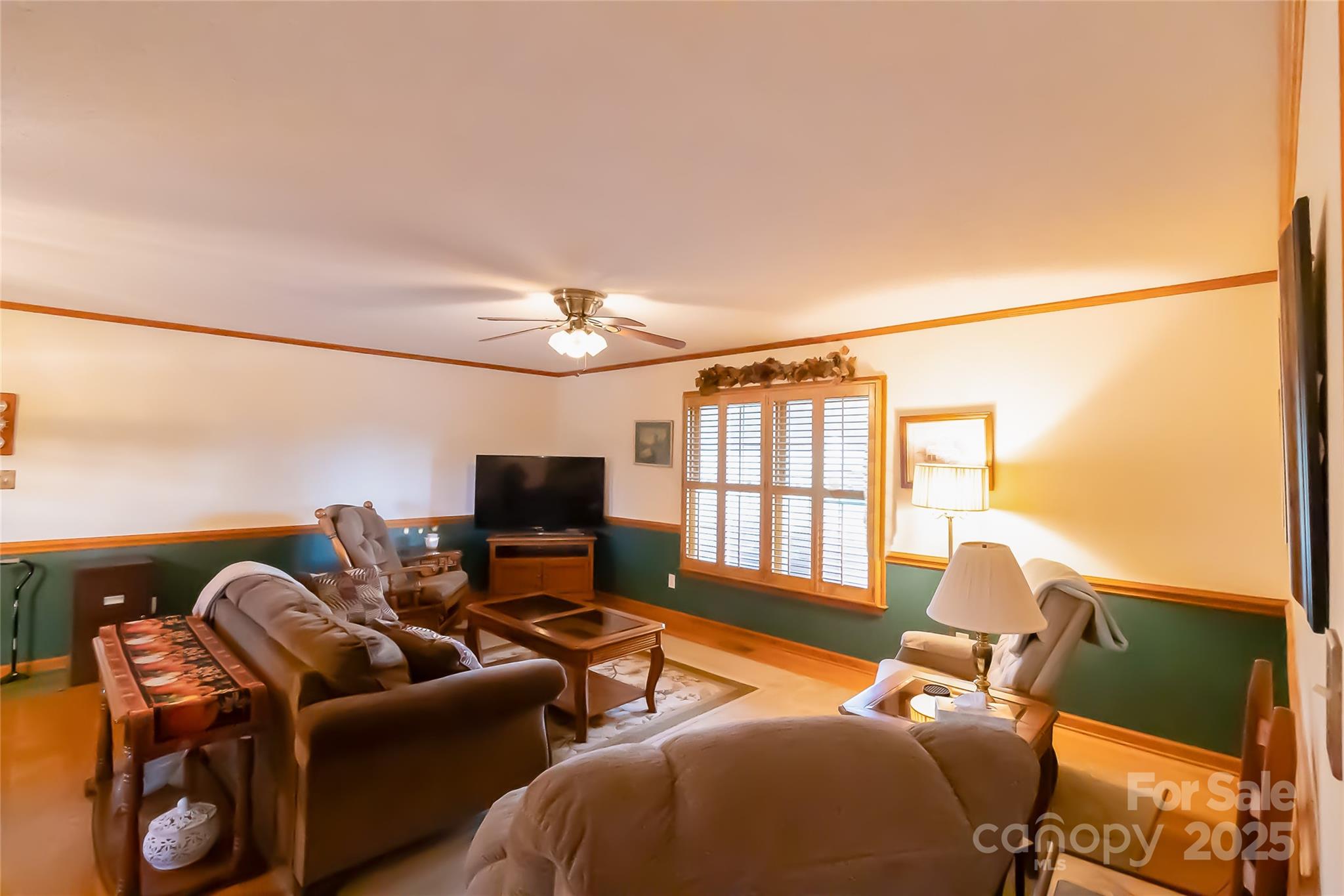 535 Holly Ridge Road Grover, NC 28073 - Photo 6 of 40 a living room with furniture a flat screen tv and a floor to ceiling window