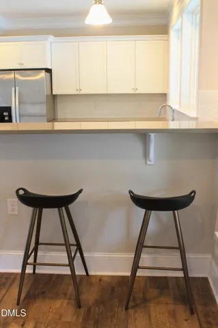 a kitchen with a wooden floor and a table