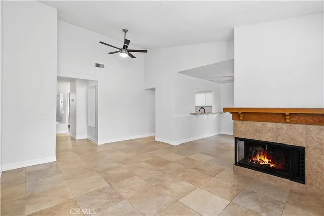 an empty room with a ceiling fan and a window