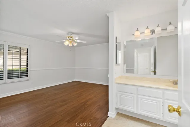 a bathroom with a granite countertop sink a toilet and a mirror
