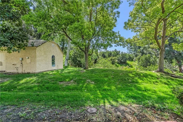 a view of backyard of house with green space