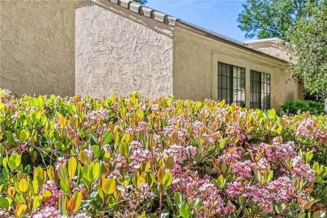 a front view of a house with a flower garden