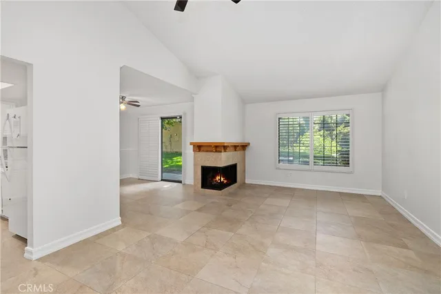 a view of a room with a fireplace and window