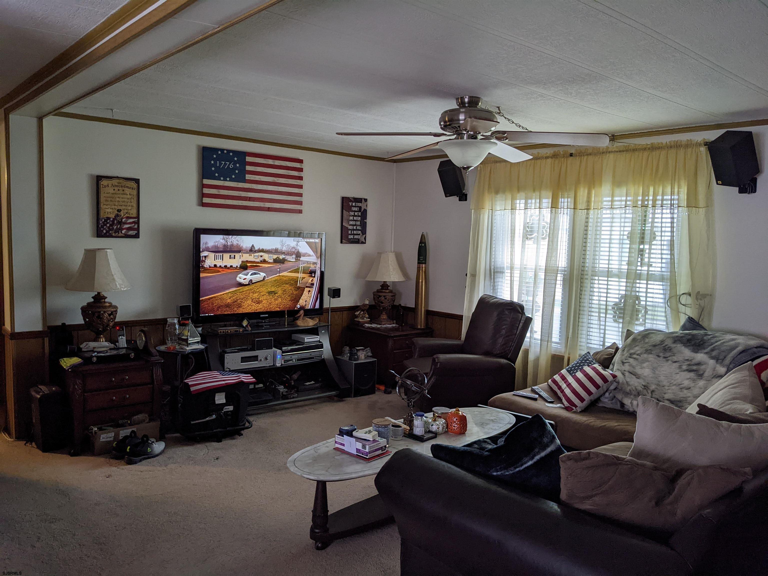 577 Miles Standish Lane Buena, NJ 08310 - Photo 11 of 25 a living room with furniture and a flat screen tv