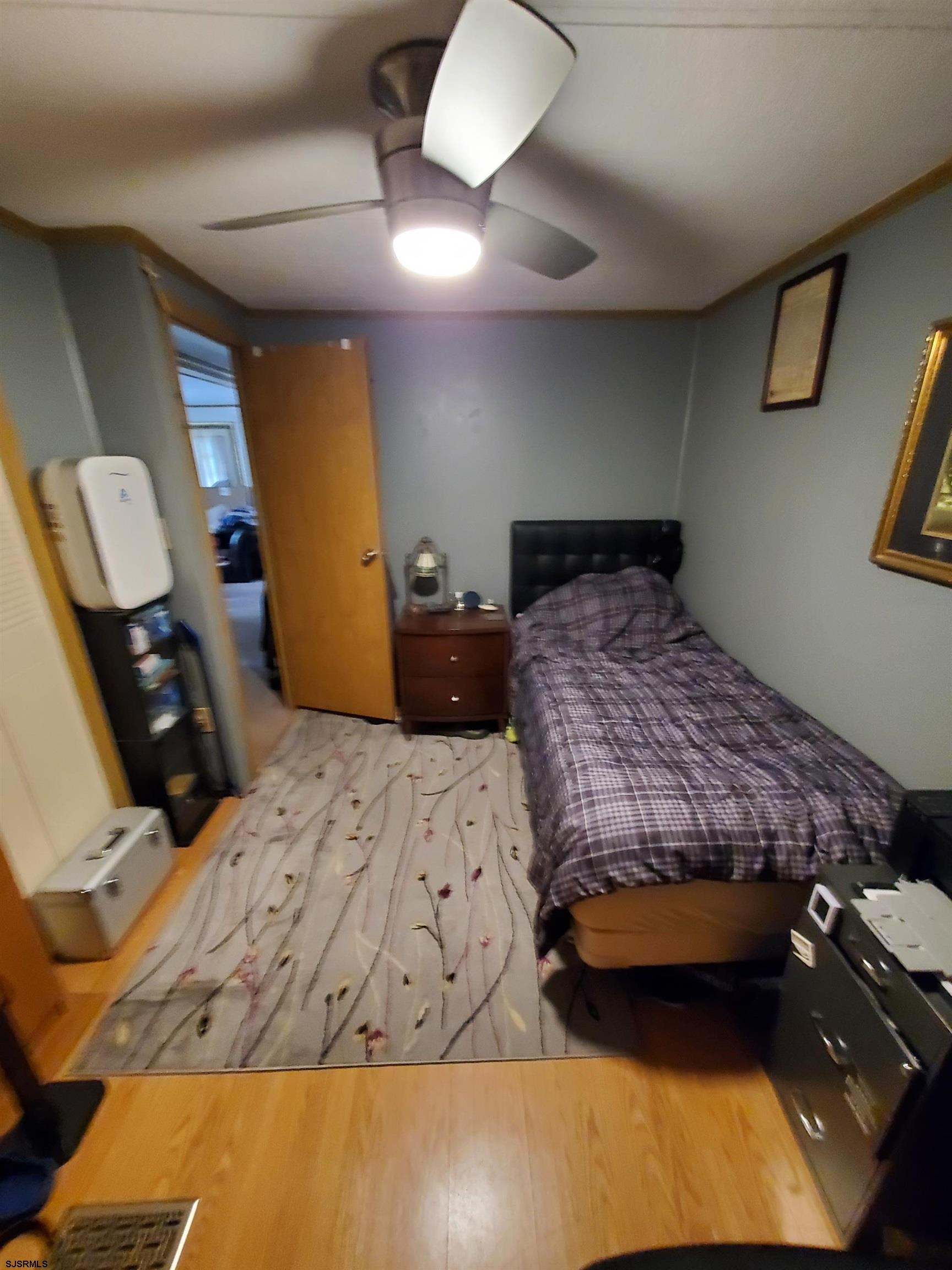 577 Miles Standish Lane Buena, NJ 08310 - Photo 17 of 25 a bedroom with a bed and a lamp