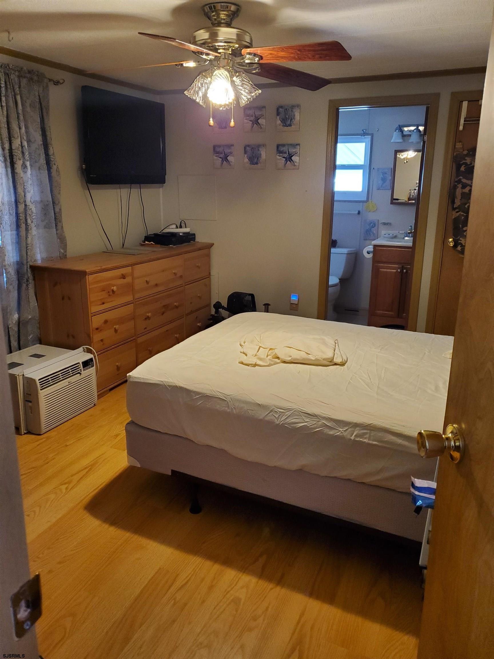 577 Miles Standish Lane Buena, NJ 08310 - Photo 18 of 25 a bedroom with a bed and flat screen tv