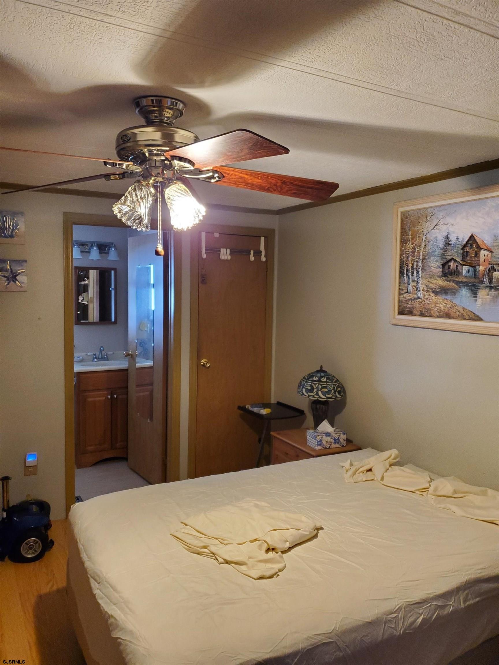 577 Miles Standish Lane Buena, NJ 08310 - Photo 20 of 25 a bedroom with a bed and a chandelier