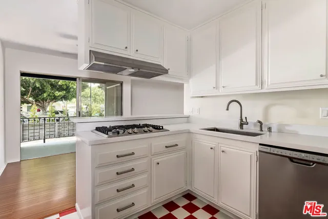 a kitchen with appliances cabinets and a sink