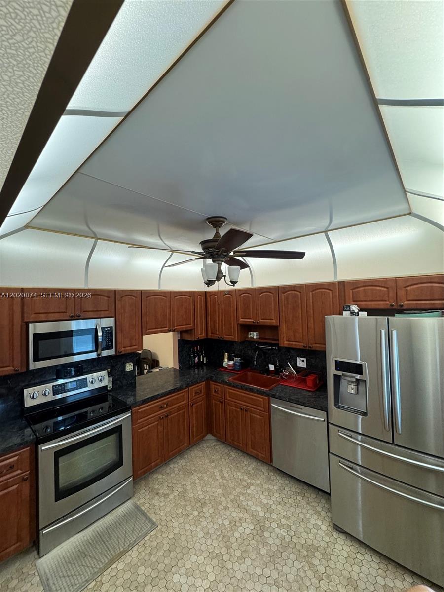 6731 Cypress Road, Unit 410 Plantation, FL 33317 - Photo 11 of 15 a kitchen with stainless steel appliances and a sink