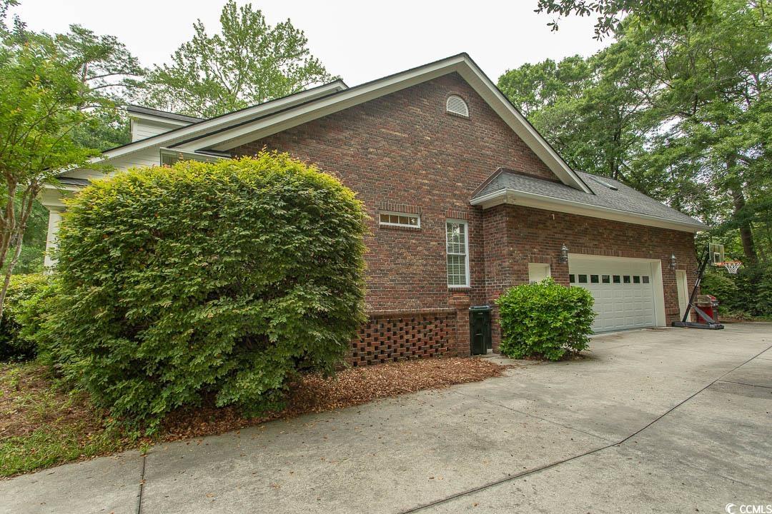 4535 Carriage Run Circle Murrells Inlet, SC 29576 - Photo 33 of 40 View of side of home with concrete driveway, brick