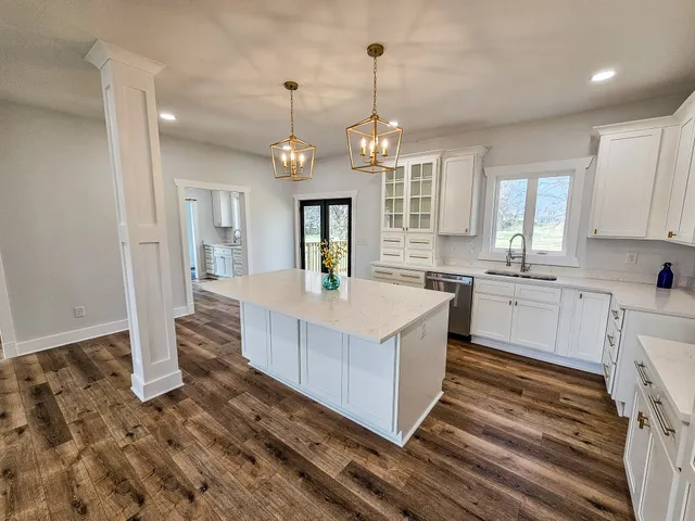 a kitchen with cabinets and wooden floor