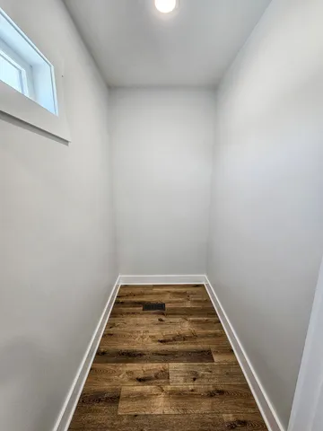 a view of a room with wooden floor and bathroom