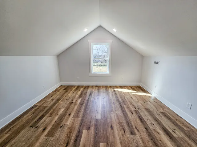 a bathroom with a granite countertop sink a toilet and bathtub