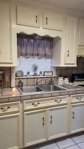 a stove top oven sitting inside of a kitchen