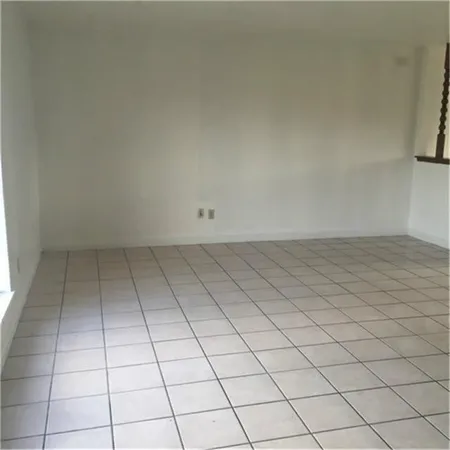 a view of a room with white tiles