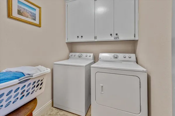 a kitchen with kitchen island granite countertop a sink cabinets and stainless steel appliances