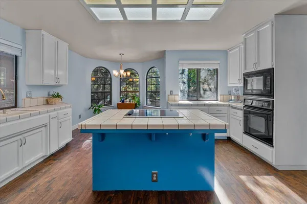 a kitchen with a sink stove and cabinets