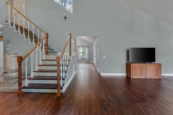 a view of entryway and hall with wooden floor