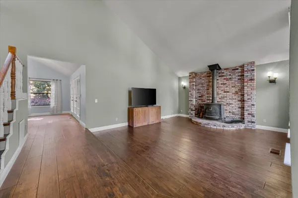 wooden floor in an empty room with a fireplace