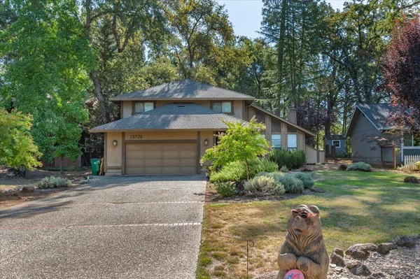 a view of an house with backyard space and balcony