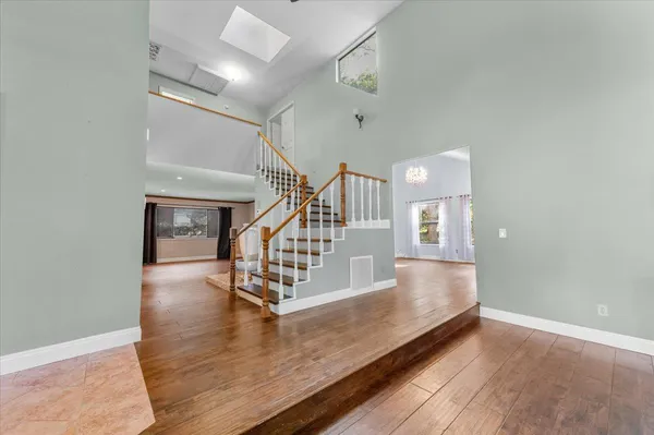 a view of entryway and hall with wooden floor