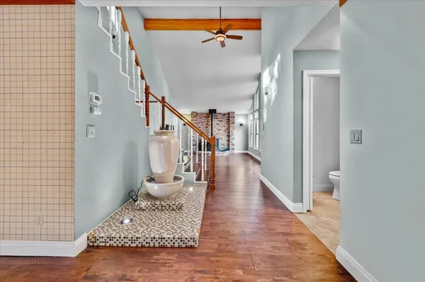 a view of entryway and hall with wooden floor