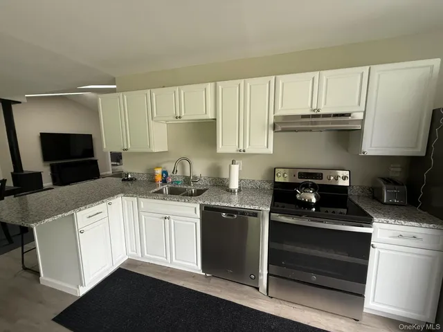 a kitchen with a sink stove and cabinets