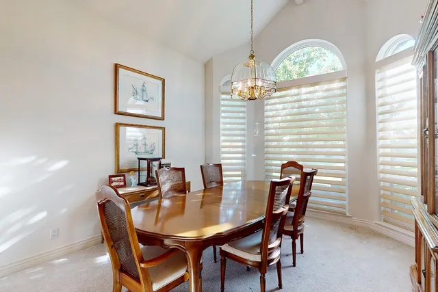 a kitchen with stainless steel appliances granite countertop a sink a stove and refrigerator