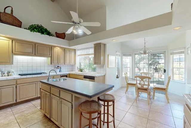 a view of a chair and table in backyard of the house