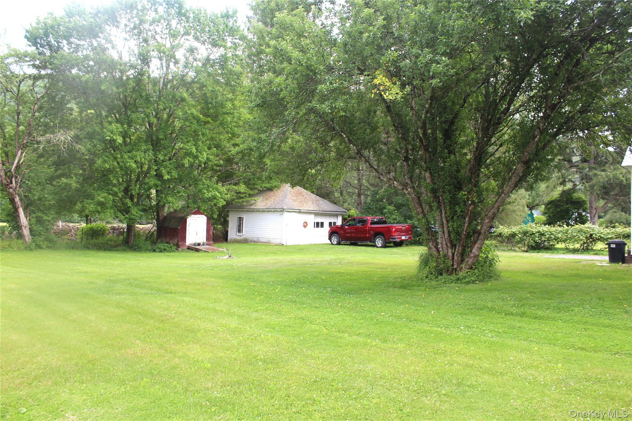 196 Rockland Road Roscoe, NY 12776 - Photo 5 of 38 Expansive green lawn with mature trees providing natural shade