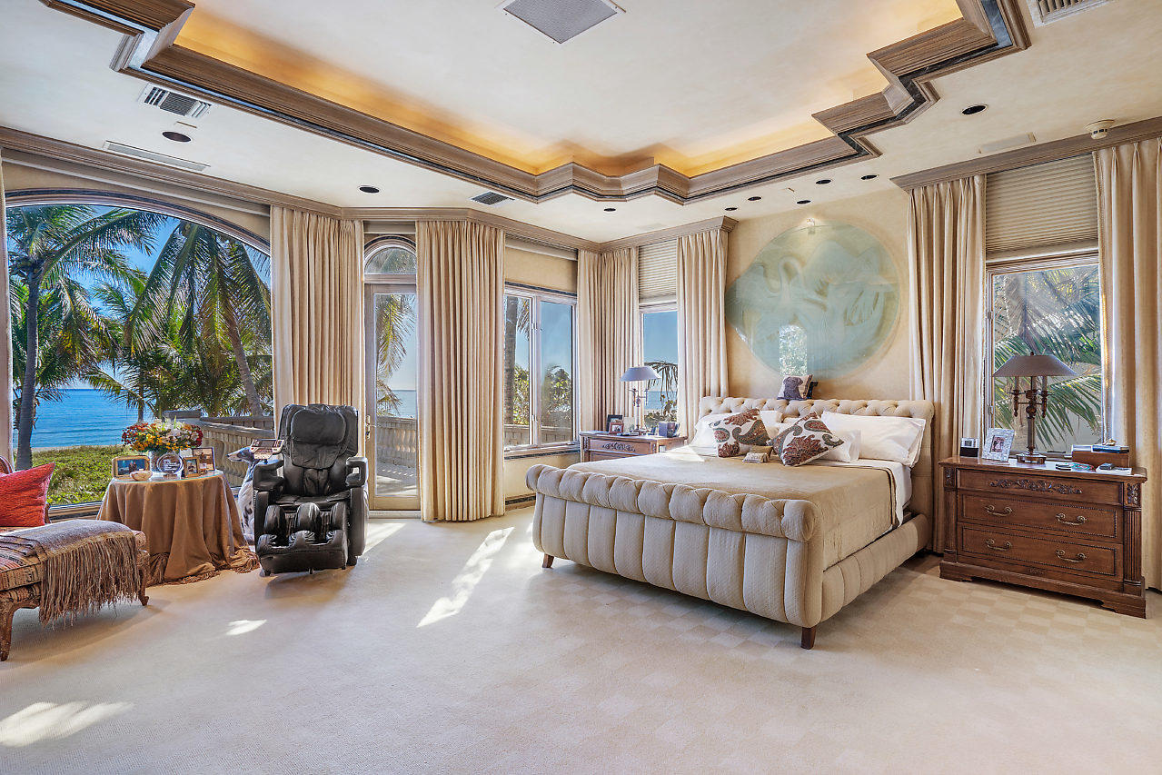 719 North Ocean Boulevard Delray Beach, FL 33483 - Photo 29 of 56 a bedroom with bed and glass door