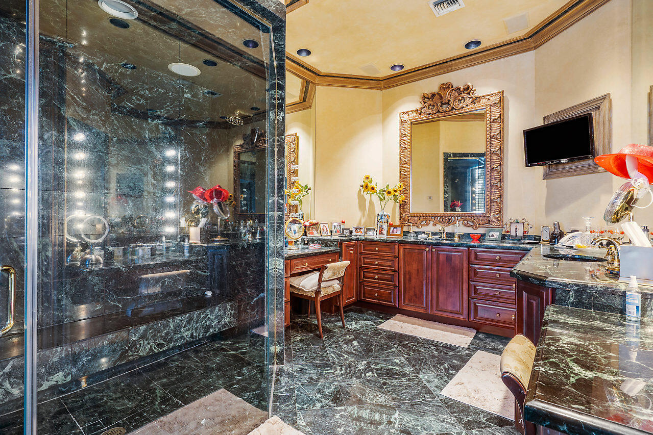 719 North Ocean Boulevard Delray Beach, FL 33483 - Photo 32 of 56 a room with granite countertop furniture and a flat screen tv