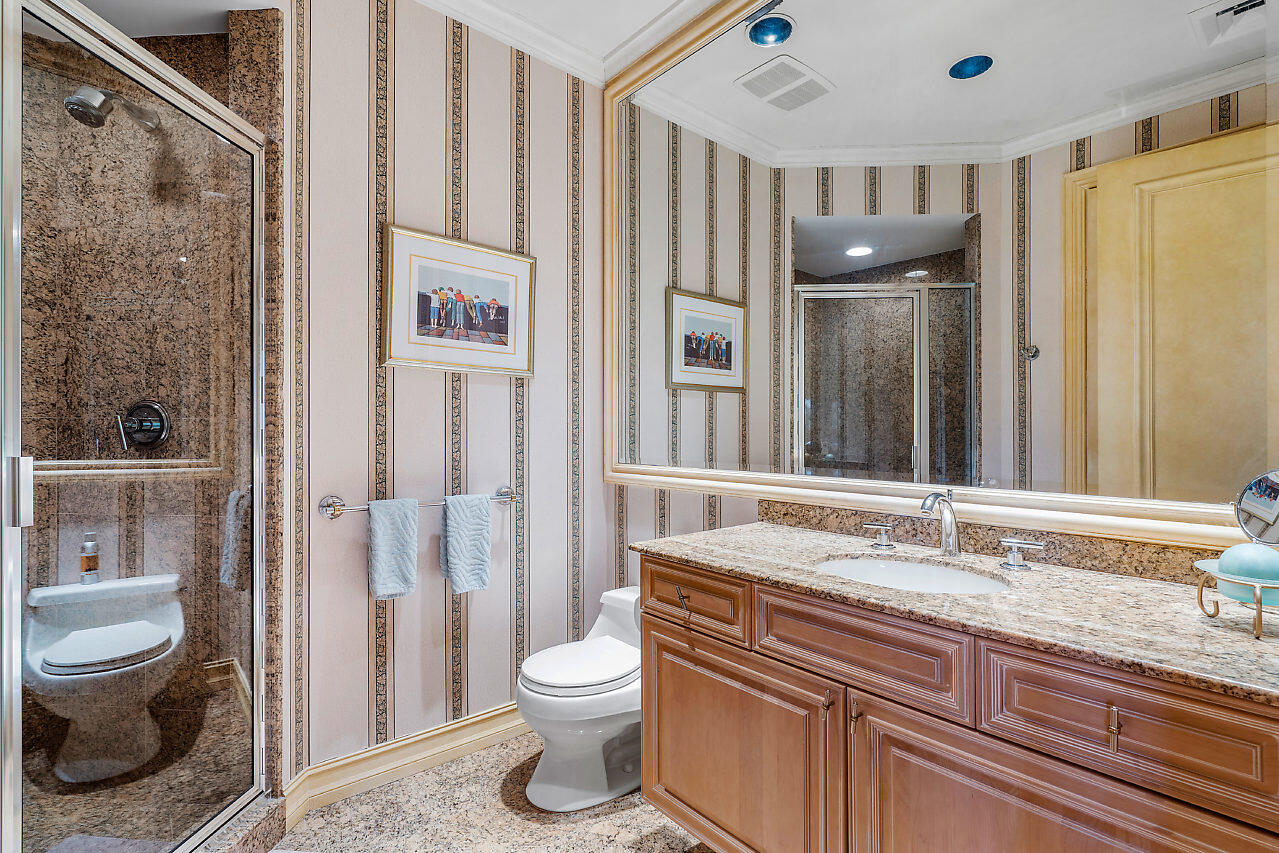 719 North Ocean Boulevard Delray Beach, FL 33483 - Photo 39 of 56 a bathroom with a granite countertop sink toilet and shower
