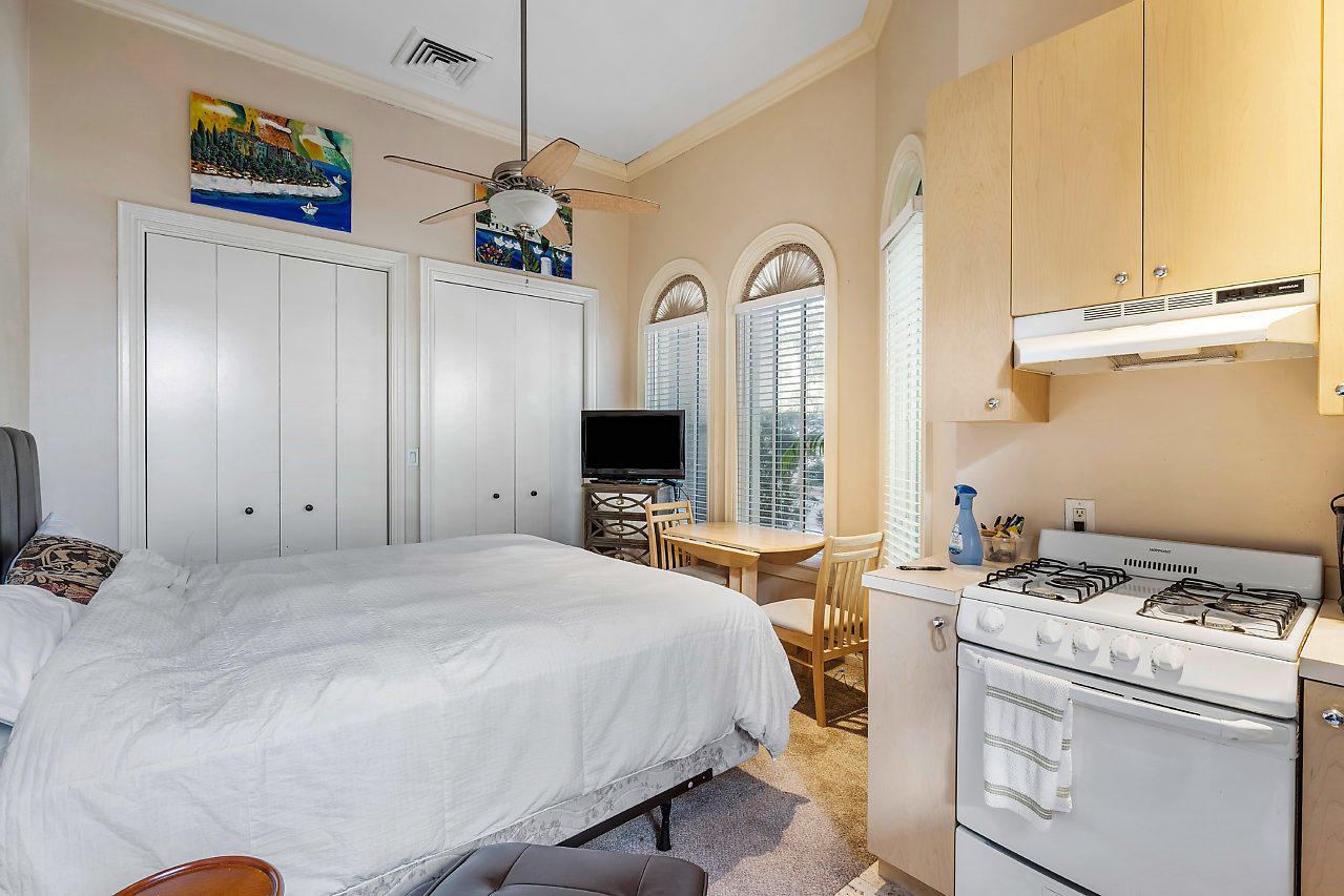 719 North Ocean Boulevard Delray Beach, FL 33483 - Photo 42 of 56 a bedroom with a bed and a flat screen tv