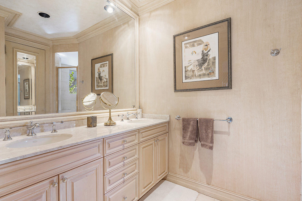 719 North Ocean Boulevard Delray Beach, FL 33483 - Photo 45 of 56 a bathroom with a double vanity sink and a mirror