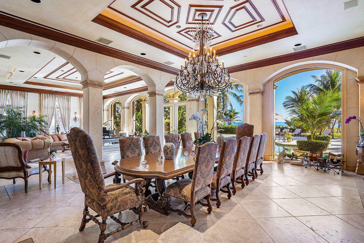 719 North Ocean Boulevard Delray Beach, FL 33483 - Photo 9 of 56 a view of a dining room with furniture a chandelier and large windows