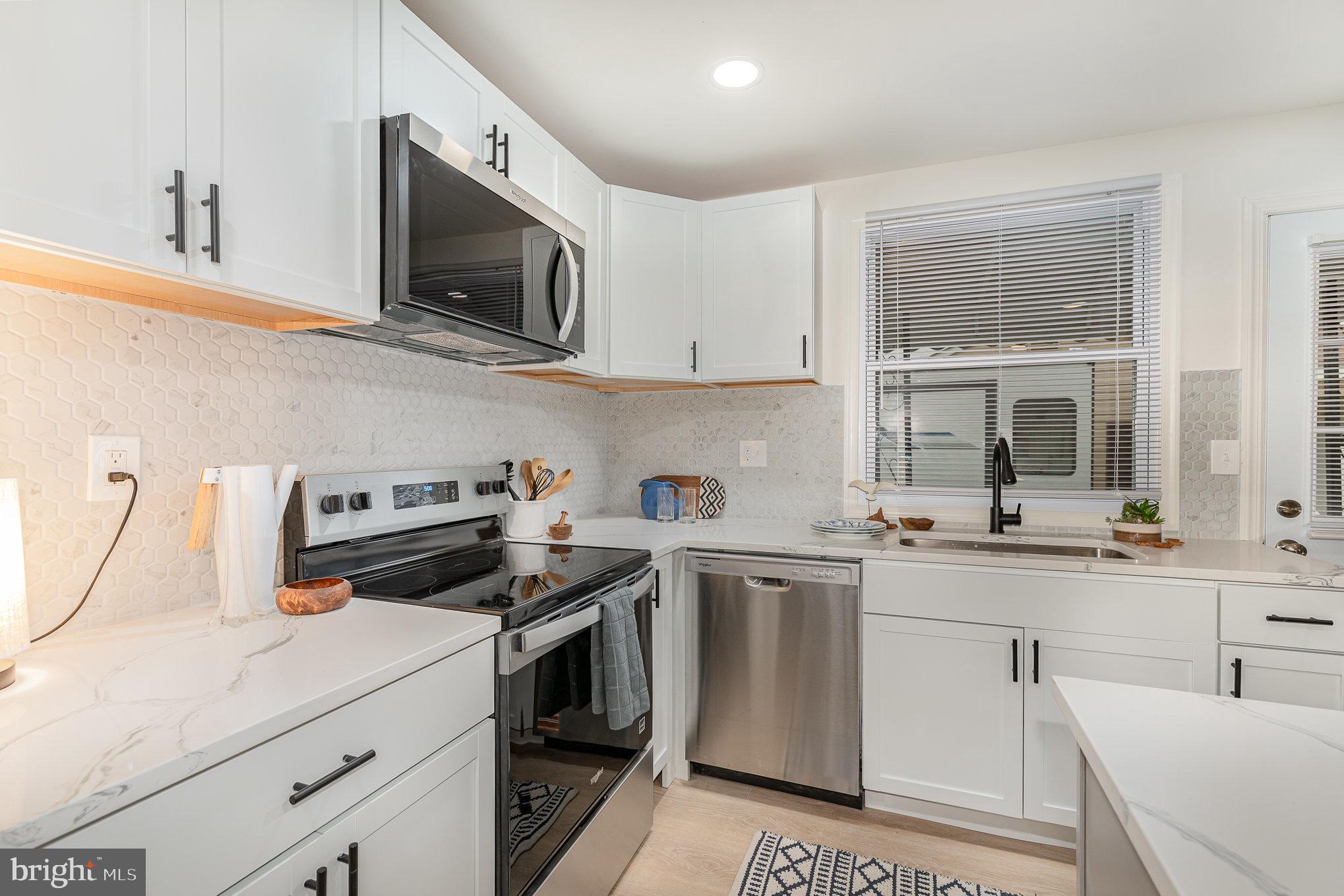 67 Torque Way Baltimore, MD 21220 - Photo 3 of 18 a kitchen with a sink stove and microwave