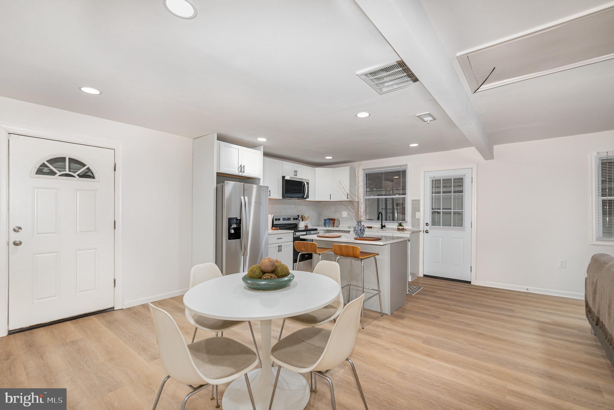 67 Torque Way Baltimore, MD 21220 - Photo 4 of 18 a kitchen with refrigerator and chairs