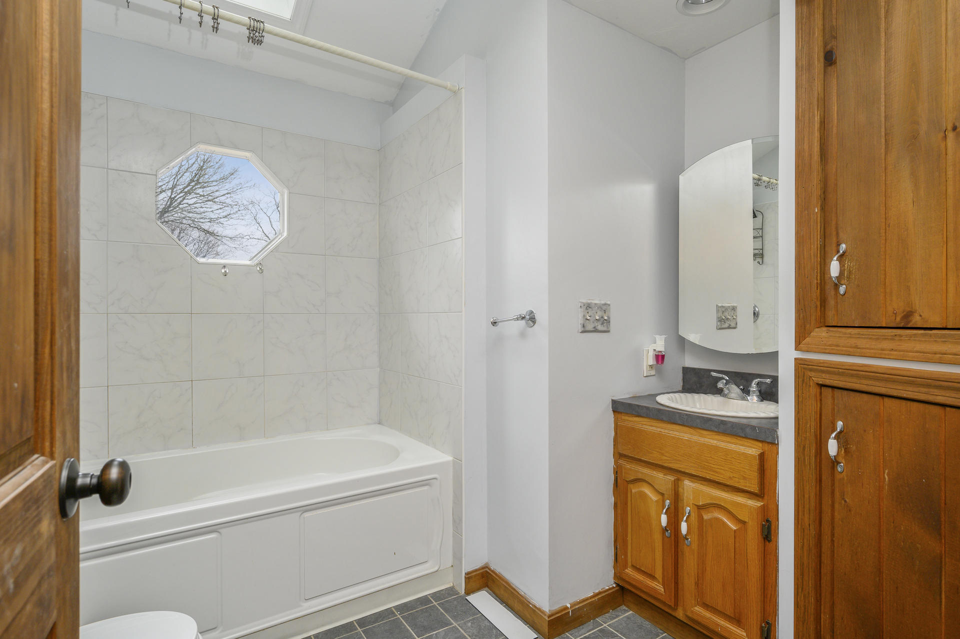 8 Indian Neck Road Wareham, MA 02571 - Photo 14 of 18 a bathroom with a granite countertop sink a mirror and a bathtub