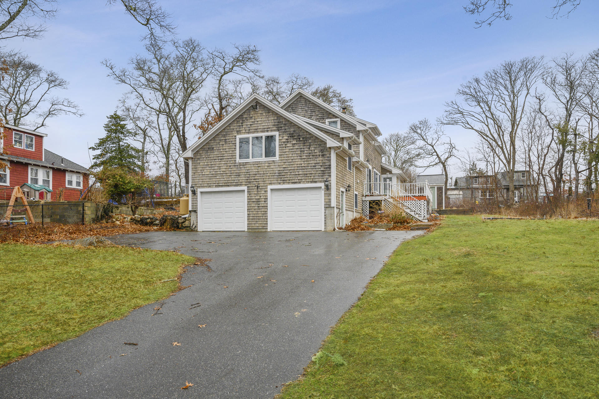 8 Indian Neck Road Wareham, MA 02571 - Photo 18 of 18 a front view of a house with a yard and garage