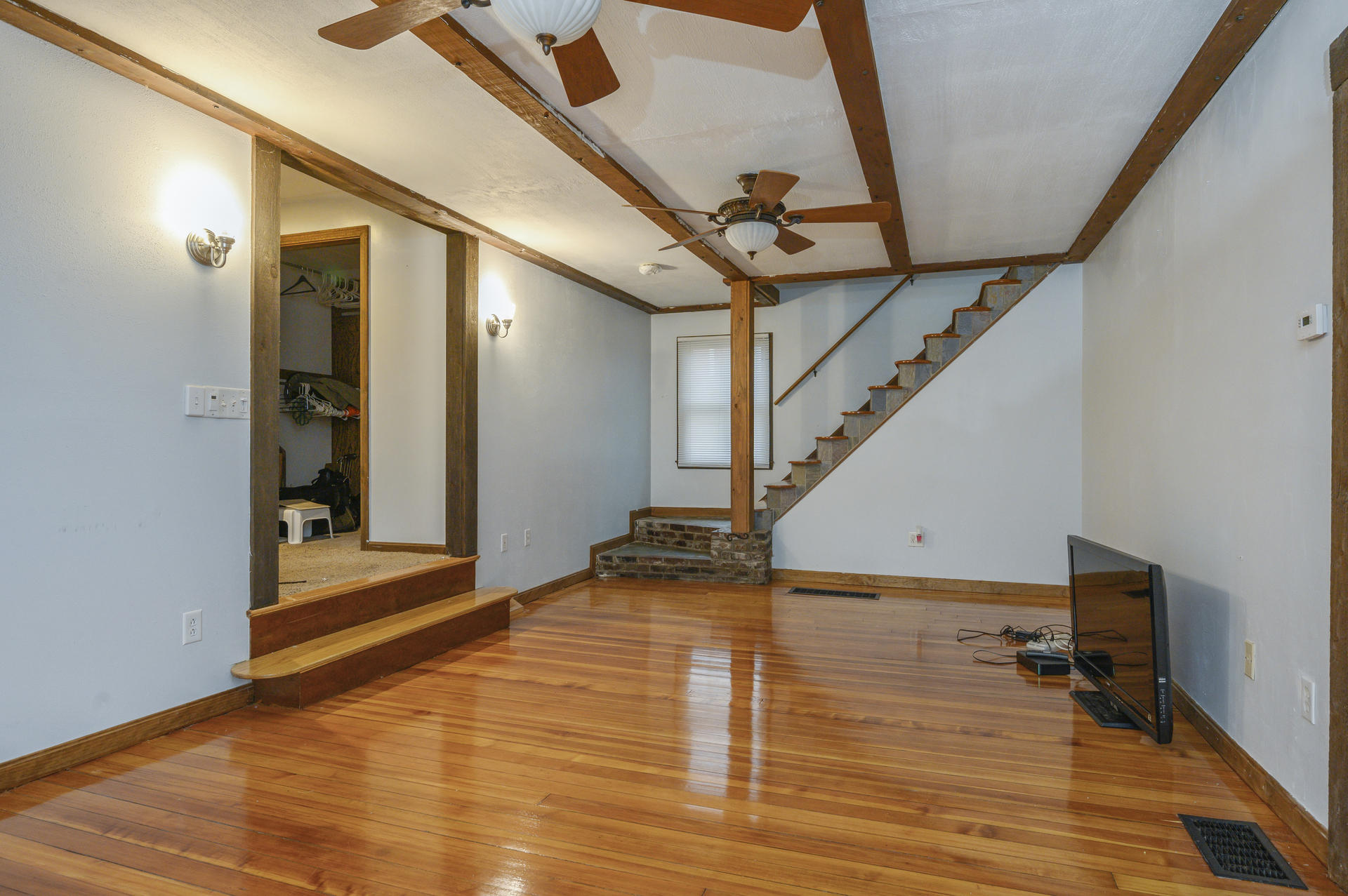 8 Indian Neck Road Wareham, MA 02571 - Photo 4 of 18 a view of a hallway with wooden floor and staircase