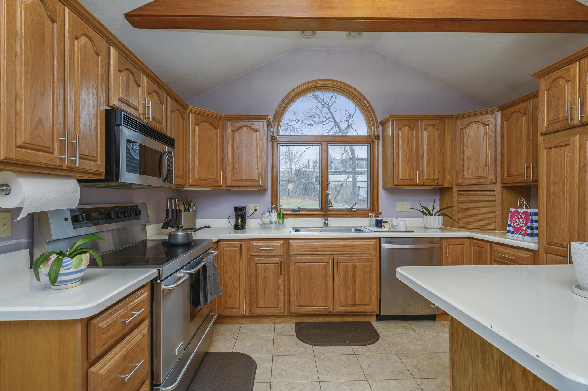 8 Indian Neck Road Wareham, MA 02571 - Photo 9 of 18 a kitchen with stainless steel appliances granite countertop a sink a stove cabinets counter space and a window