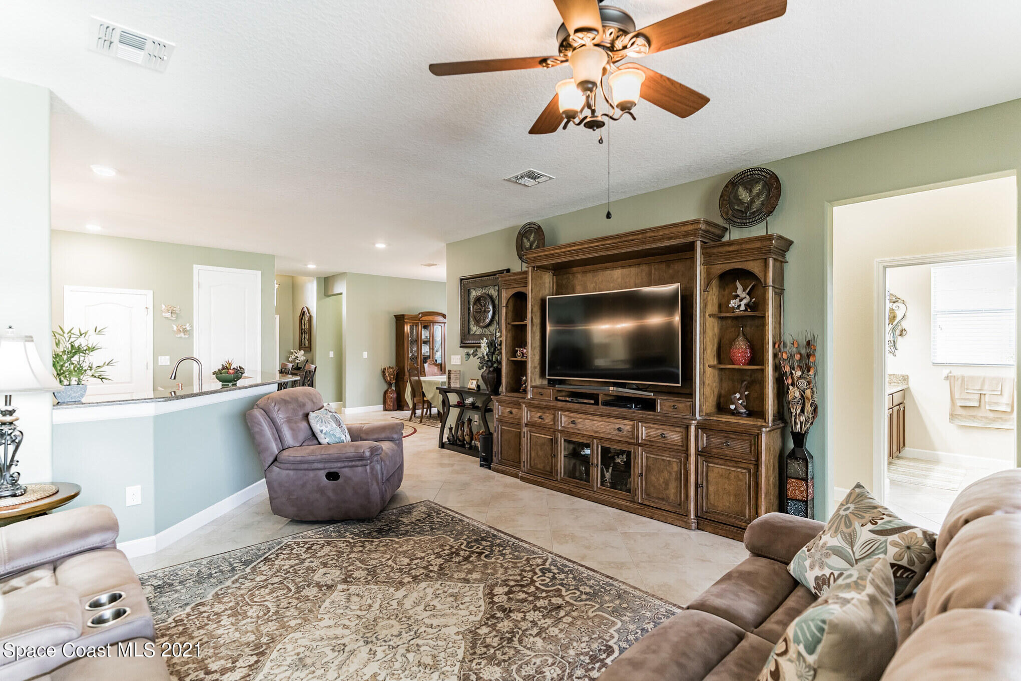 3242 Balboa Place Melbourne, FL 32940 - Photo 14 of 34 a living room with furniture and a flat screen tv