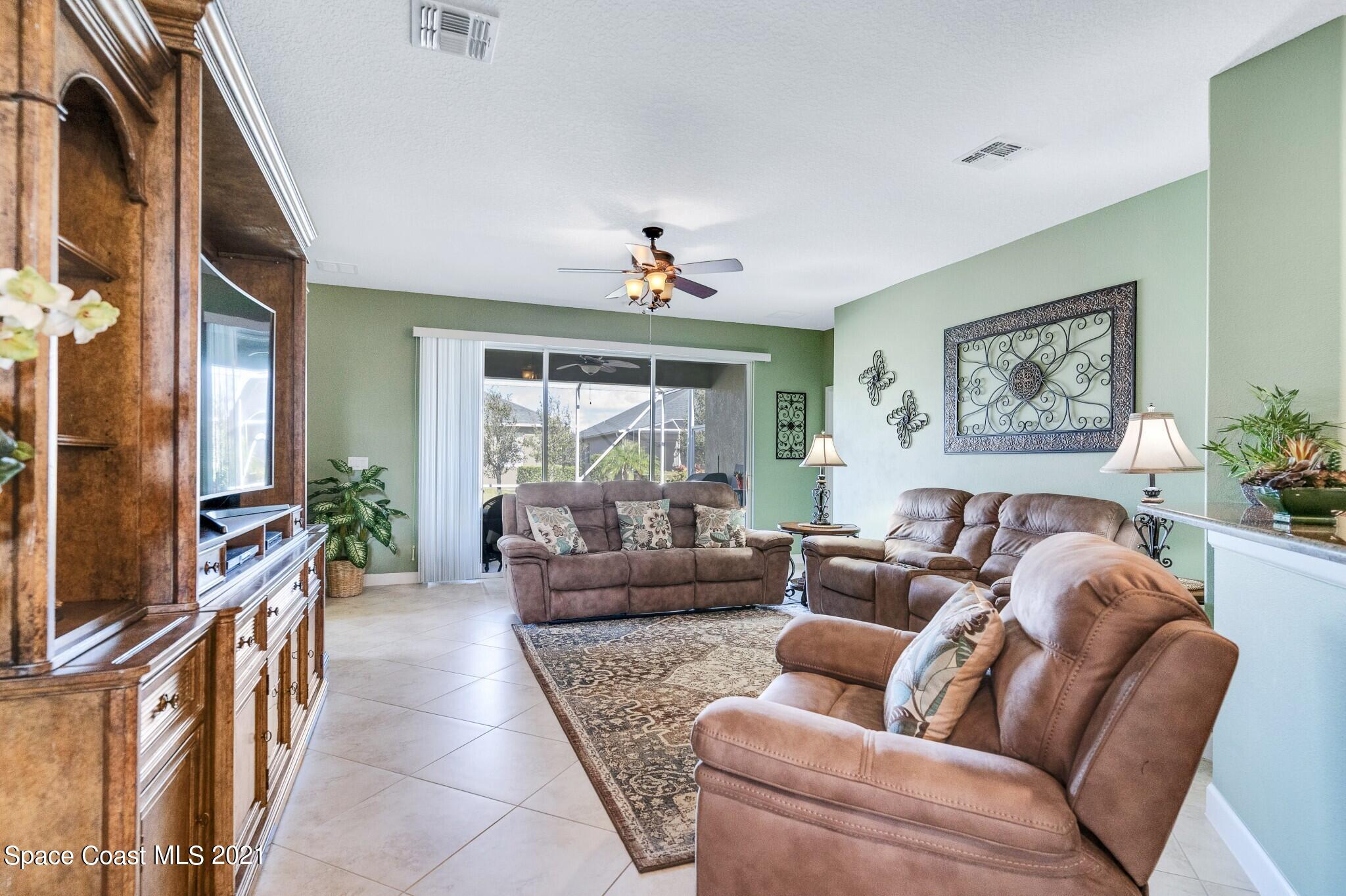 3242 Balboa Place Melbourne, FL 32940 - Photo 15 of 34 a living room with furniture fireplace and a large window