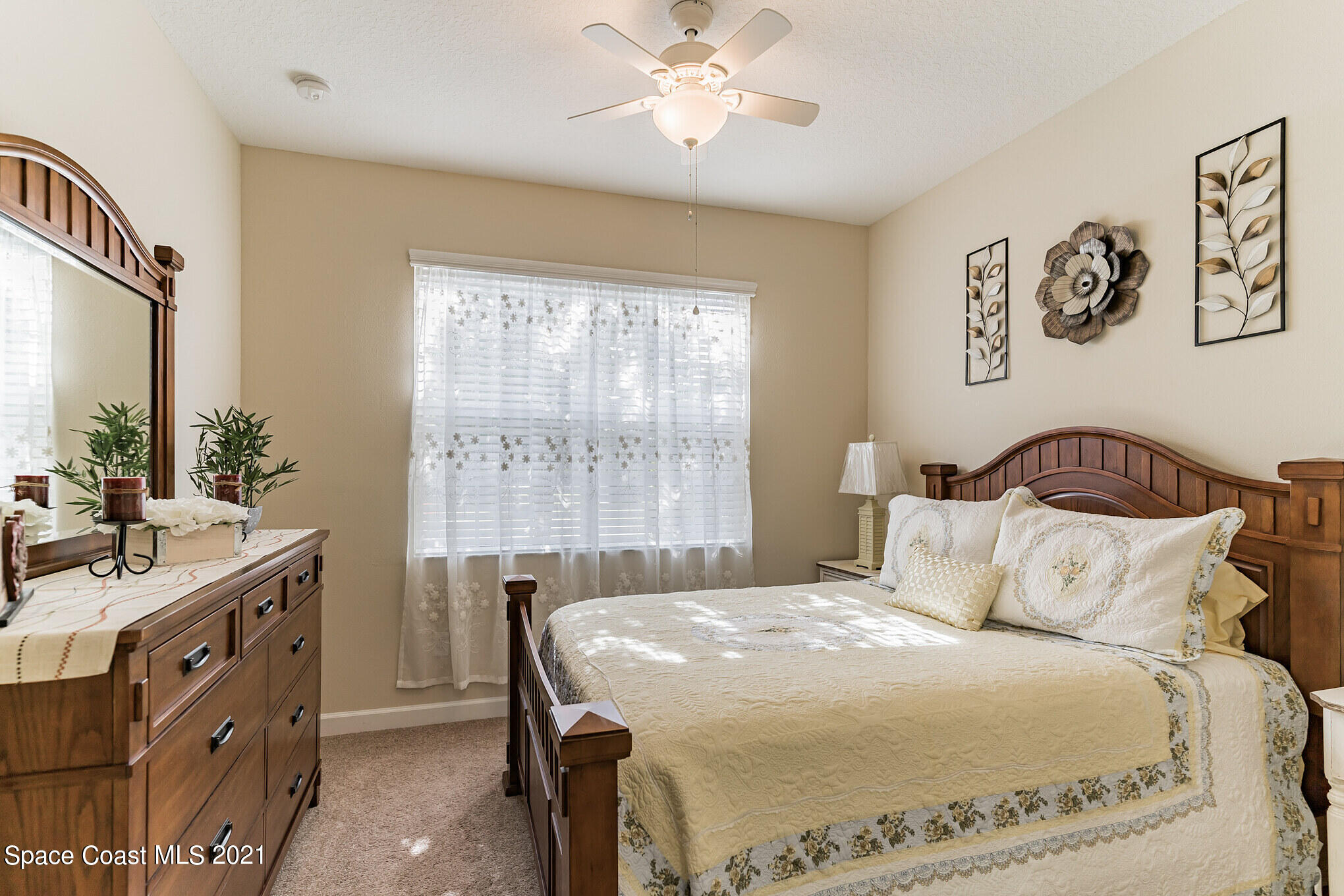 3242 Balboa Place Melbourne, FL 32940 - Photo 16 of 34 a bedroom with a bed and a chandelier