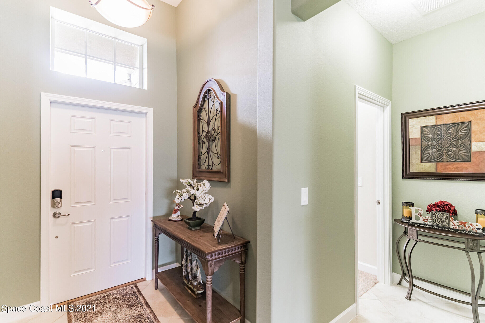 3242 Balboa Place Melbourne, FL 32940 - Photo 18 of 34 a view of two room that has a table and a dresser in it