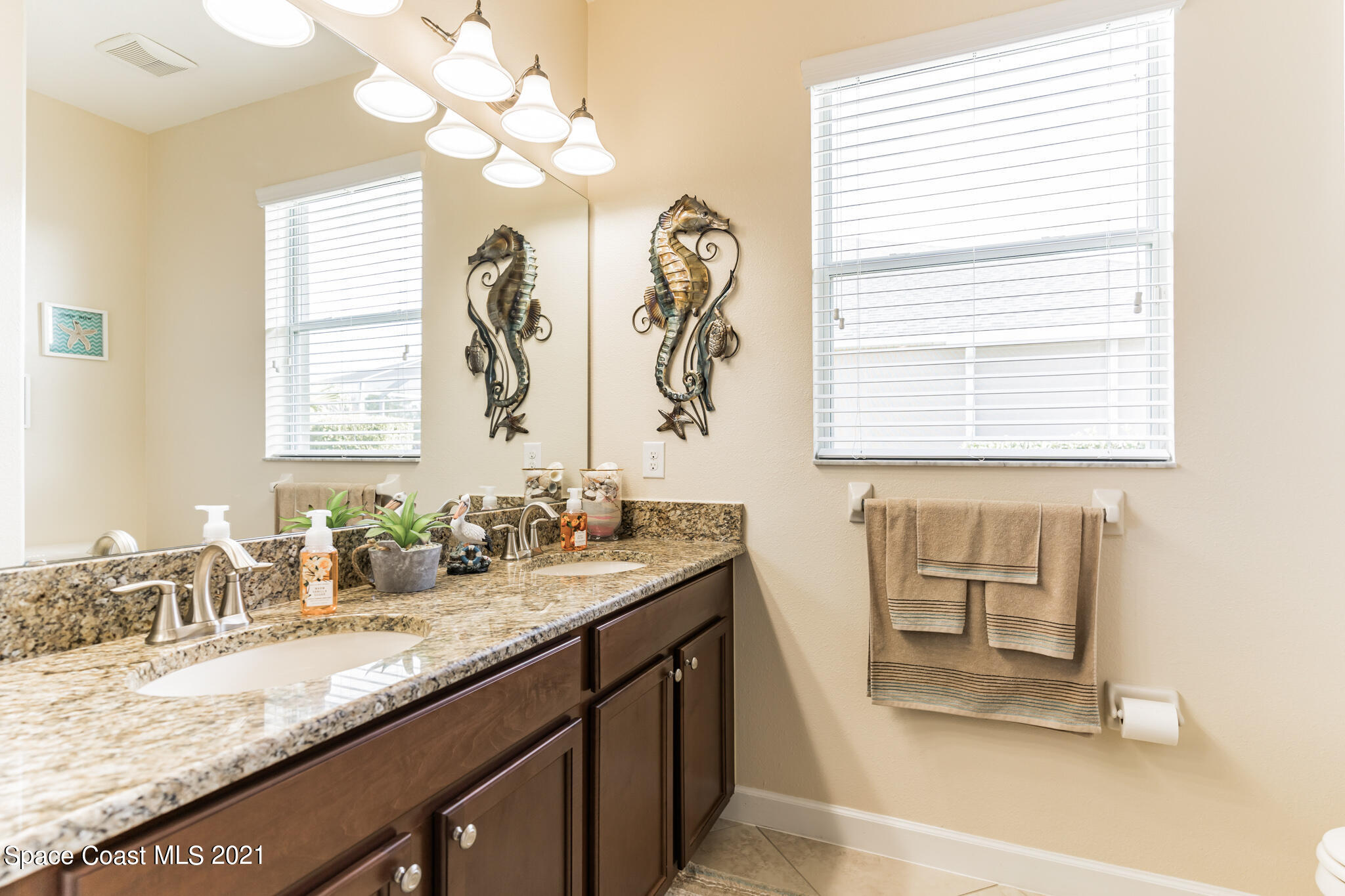 3242 Balboa Place Melbourne, FL 32940 - Photo 20 of 34 a bathroom with a granite countertop sink and a mirror