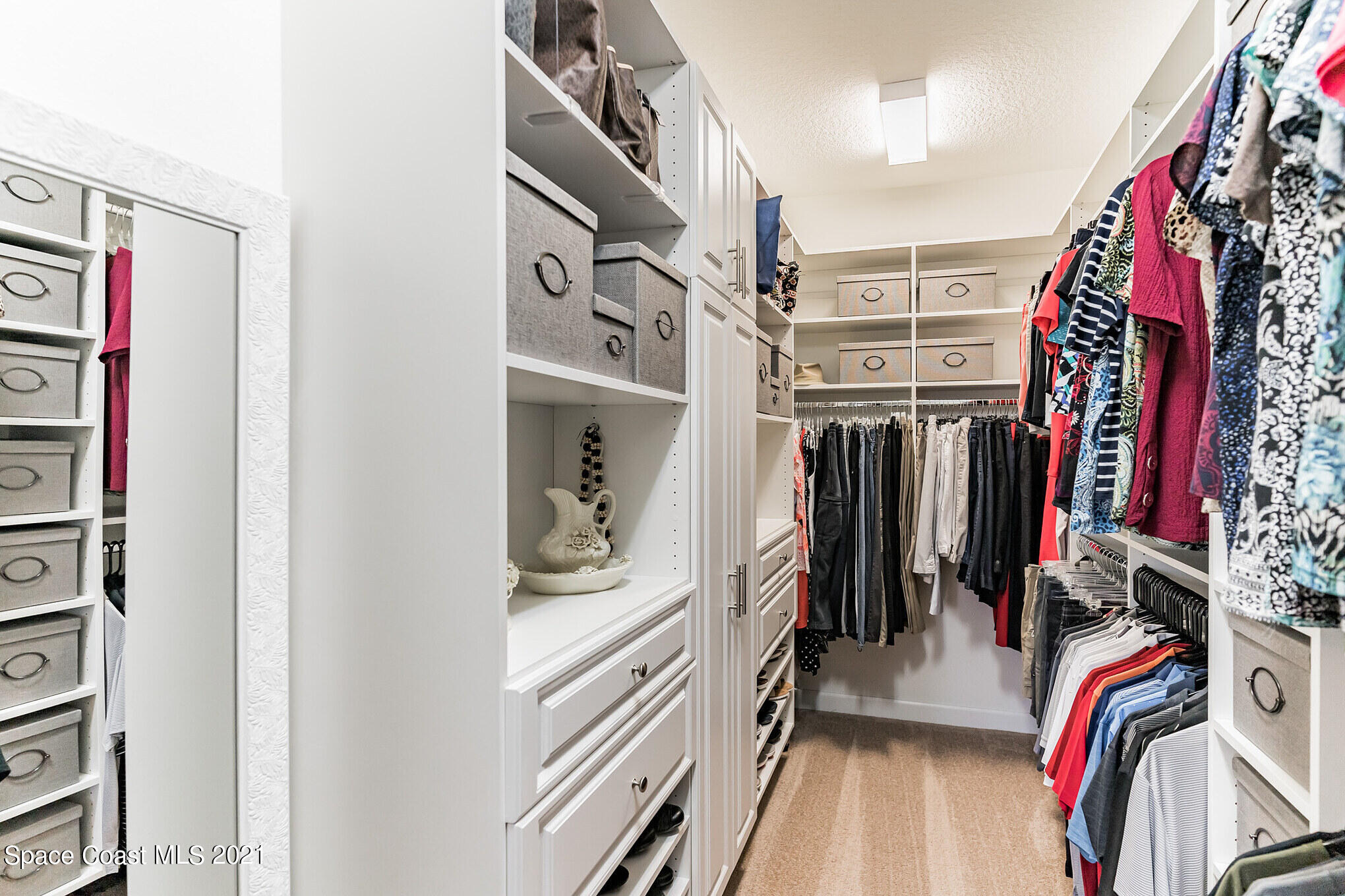 3242 Balboa Place Melbourne, FL 32940 - Photo 21 of 34 a view of walk in closet with clothes and shoes