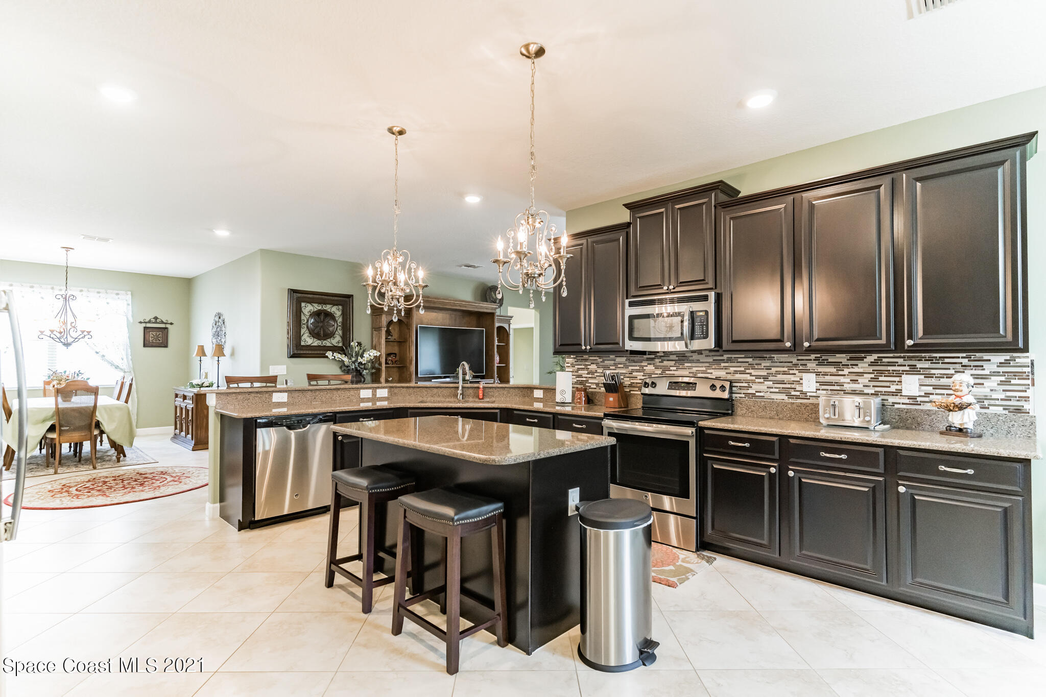 3242 Balboa Place Melbourne, FL 32940 - Photo 4 of 34 a kitchen with a sink counter top space appliances and cabinets